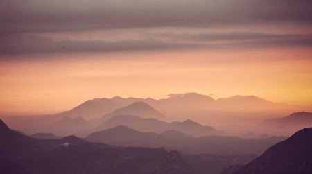 Mountain range in the clouds. Beautiful panoramic landscape.