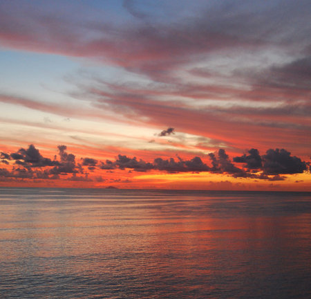 Beautiful sunset over the sea. Colorful sky and clouds.の写真素材
