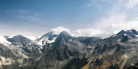 Panoramic view of snow-capped mountains in the clouds