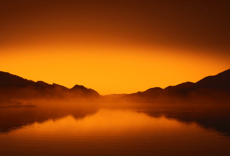 Sunrise on a lake with fog in the background, Switzerland.の写真素材