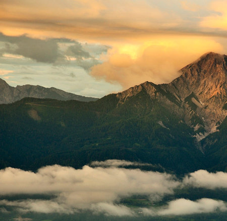 Sunset in the mountains with clouds in the foreground, Switzerland.の写真素材