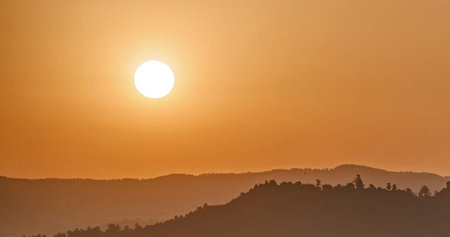 Beautiful sunrise in the mountains. The sun goes down over the mountains.の写真素材