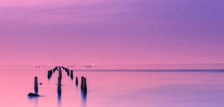 Wooden breakwater in the sea at sunset. Nature composition.の写真素材