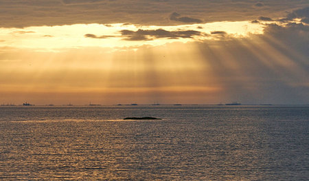 Sunset over the Baltic Sea with a small island in the foreground