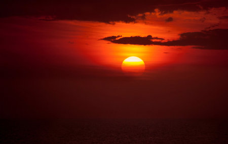 Beautiful sunset on the sea. The sun goes down over the sea.の写真素材