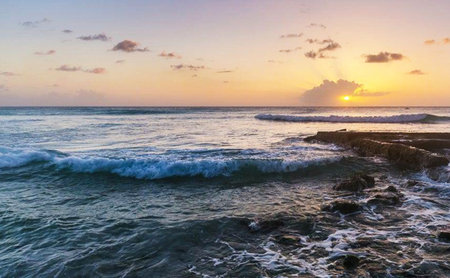 Sunset on the beach of the island of Bali, Indonesiaの写真素材