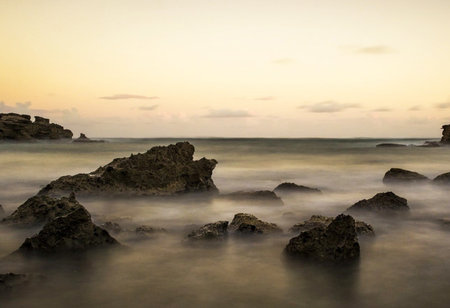 Long exposure of rocks in the sea at sunset, Taipei, Taiwan