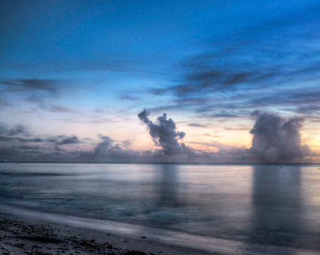 Sunset on the beach with clouds in the sky. Beautiful natural background.の写真素材