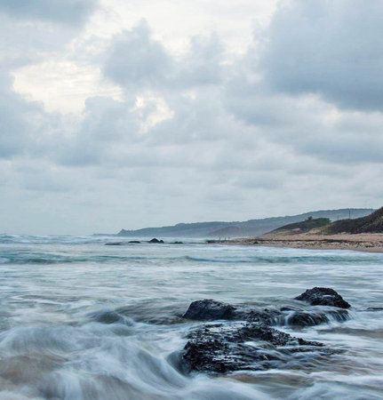 Beautiful seascape with stormy clouds and waves on the beachの写真素材