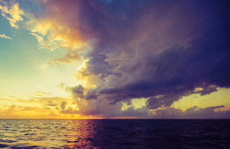 Beautiful sunset over the sea. Colorful sky with clouds.の写真素材
