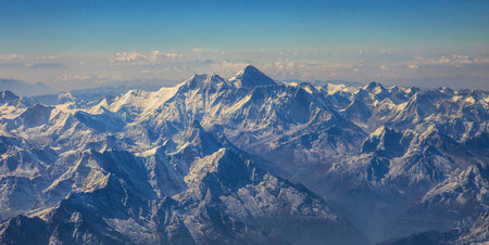 Aerial view of Himalaya mountain range with blue sky and clouds