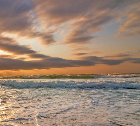 Sunset on the beach. Seascape with waves and cloudsの写真素材