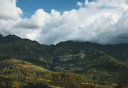 Mountain landscape with clouds and blue sky. View from the top of the mountain.の写真素材