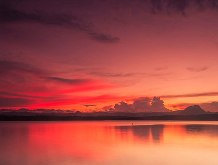 Colorful sunset over the sea with reflection of the sky in the waterの写真素材