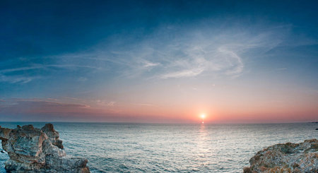 Beautiful sunset over the sea. Panoramic view of the sea at sunset.