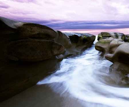 Long exposure of a rocky beach at sunset, Boulders, South Australiaの写真素材