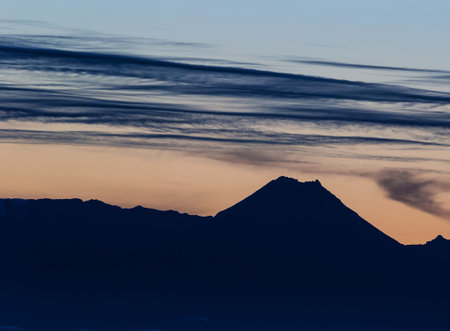 Mountains in the evening at dawn with clouds in the sky.の写真素材