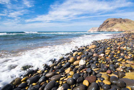 Beautiful seascape with pebbles on the foreground.の写真素材