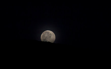 Full moon in the night sky over the mountains, natural background.の写真素材