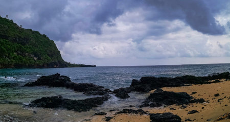 Tropical beach with a stormy sky in the background.の写真素材