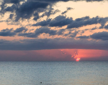 Sunset over the sea. The sun sets over the sea.の写真素材