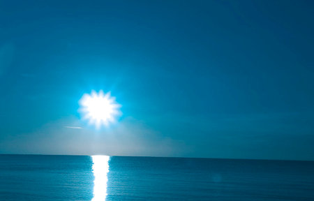 Sunset on the sea with blue sky and sunbeams.