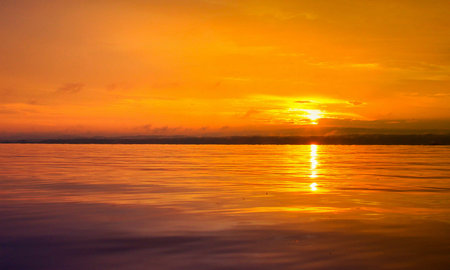Sunset on the lake. The sun is reflected in the water.