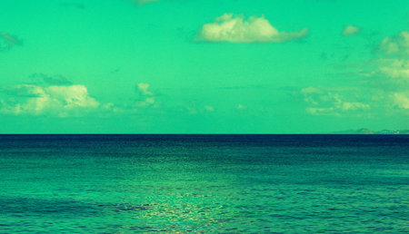Tropical beach with turquoise sea and blue sky backgroundの写真素材