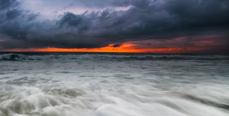 Stormy sunset over the sea. Dramatic sky, stormy clouds. Panoramaの写真素材
