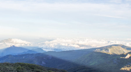 Mountain landscape with clouds and blue sky. View from the top of the mountain.の写真素材
