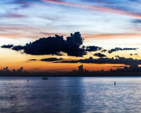Beautiful sunset at the sea. Colorful sky with clouds.の写真素材