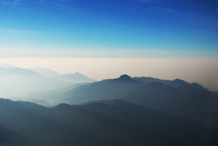 Mountains in the morning mist. View from the airplane window.
