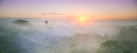 Panoramic view of sunrise over misty valley in Phu Langka National Park, Thailandの写真素材