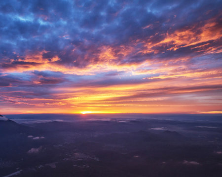 Aerial view of beautiful sunset above the clouds in the mountains.の写真素材