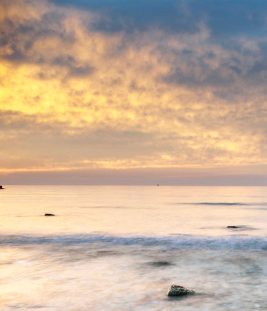 sunset on the beach, long exposure photo with motion blur effectの写真素材