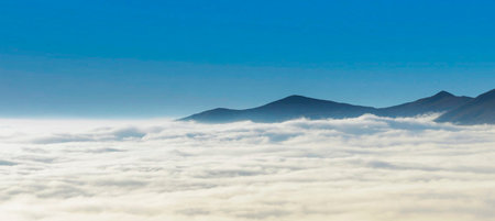 Beautiful panoramic view of clouds and mountains in the morningの写真素材