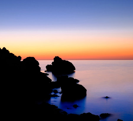 sunset on the sea with rocks and blue sky, beautiful photo digital picture