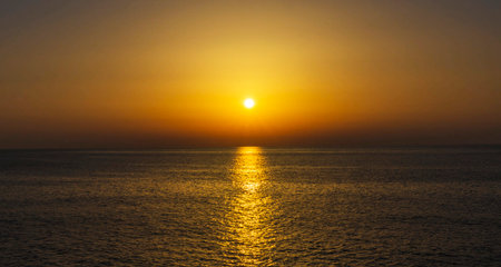 Beautiful sunset over the sea. The sun goes down over the sea.の写真素材