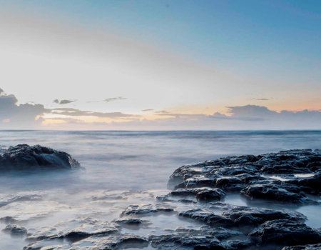 Beautiful seascape with rocks in the foreground and sea in the backgroundの写真素材