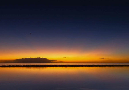 Sunset over the sea in the tropics. The sky is reflected in the water.の写真素材