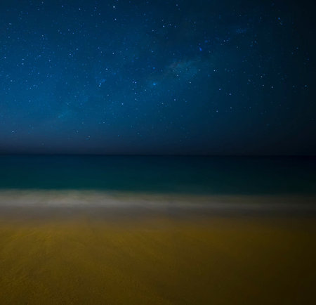 Night starry sky over a sandy beach. Long exposure photograph.