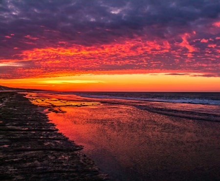 Sunset on the beach of the Baltic Sea in Liepaja, Latviaの写真素材