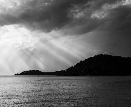 Dramatic sunset over the sea. Black and white photo.の写真素材