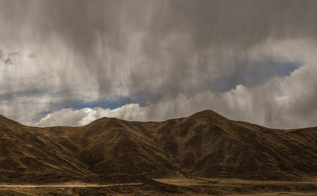 Dramatic sky with storm clouds over the hills in the desertの写真素材