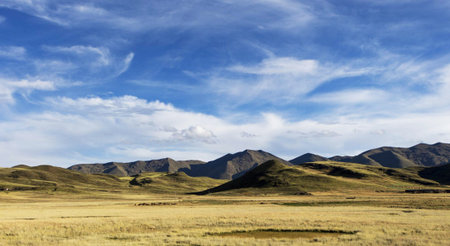 Mongolian grassland scenery with blue sky and clouds.の写真素材