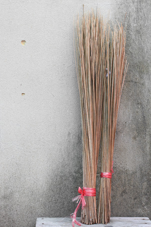 Coconut broom stick on brick wallの写真素材