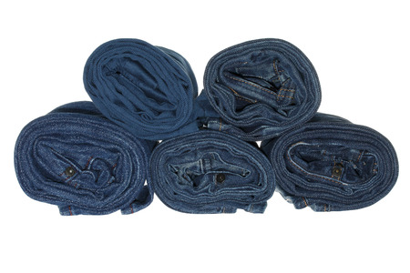 Stack of rolled jeans isolated on white backgroundの写真素材