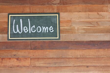 wooden frame WELCOME over old wooden backgroundの写真素材