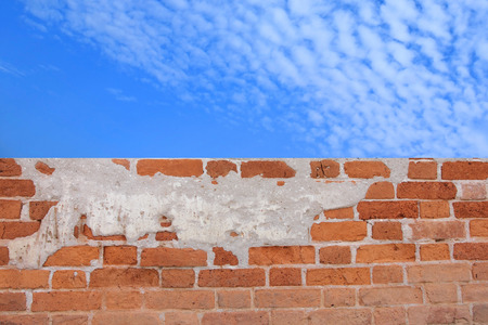 Brick wall under a blue sky.の写真素材