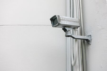 security camera on the white wallの写真素材